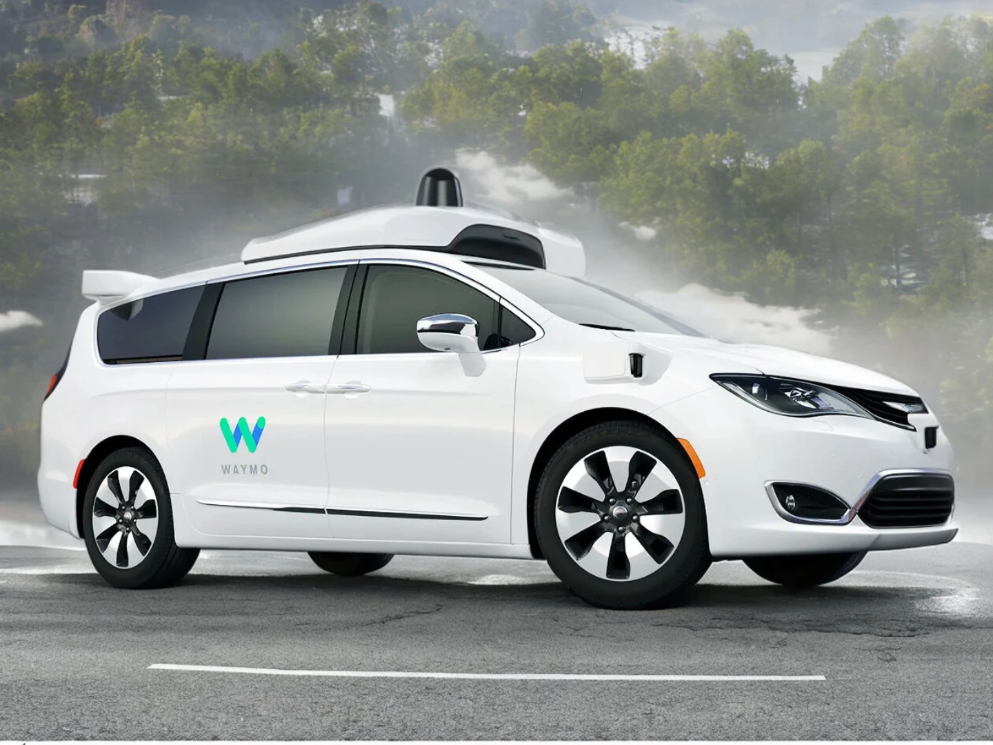 A white Waymo self-driving minivan equipped with sensors and autonomous driving technology, parked on a road with a misty forest backdrop. The vehicle represents real-life agentic systems in autonomous transportation.